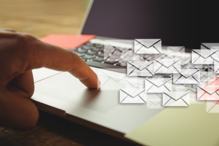 hand tounching laptop many envelopes 1134 189